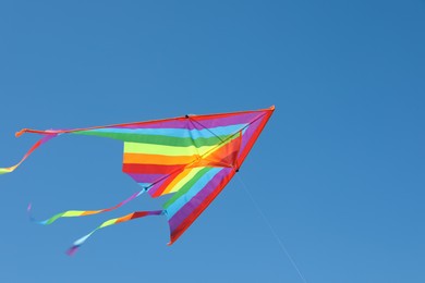 Photo of One colorful kite flying in blue sky