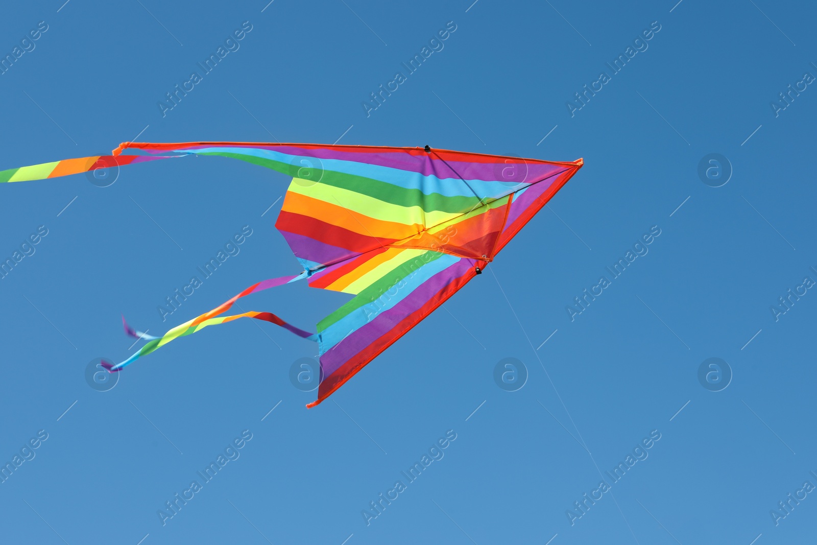 One colorful kite flying in blue sky Photo of One colorful kite flying in blue sky