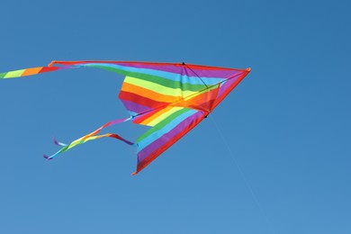 Photo of One colorful kite flying in blue sky