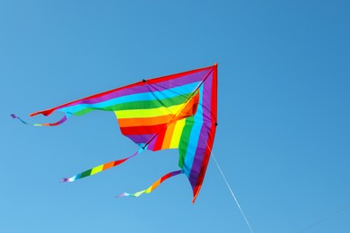 Photo of One colorful kite flying in blue sky