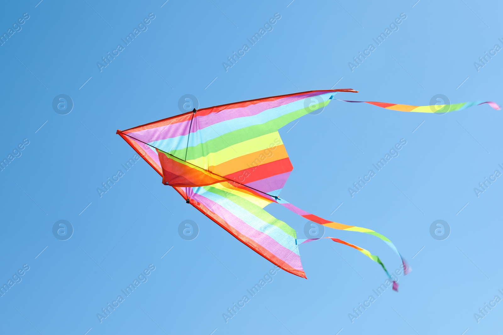 One colorful kite flying in blue sky Photo of One colorful kite flying in blue sky