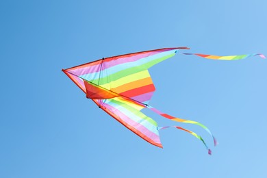 Photo of One colorful kite flying in blue sky