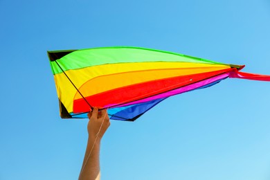 Photo of Man with kite against blue sky, closeup