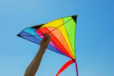 Photo of Man with kite against blue sky, closeup