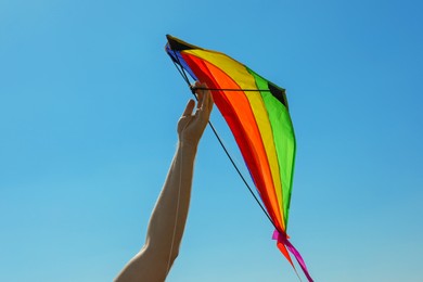 Photo of Man with kite against blue sky, closeup