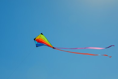 Photo of One colorful kite flying in blue sky