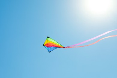 Photo of One colorful kite flying in blue sky