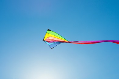 Photo of One colorful kite flying in blue sky