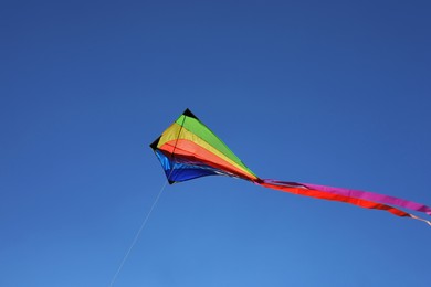 Photo of One colorful kite flying in blue sky