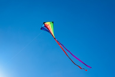 Photo of One colorful kite flying in blue sky