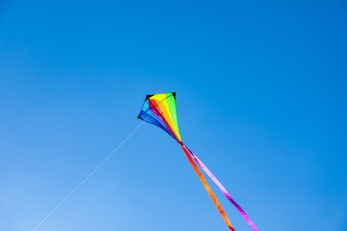 Photo of One colorful kite flying in blue sky