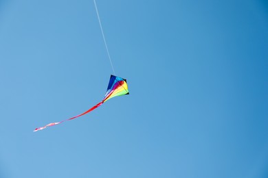 Photo of One colorful kite flying in blue sky