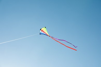 Photo of One colorful kite flying in blue sky