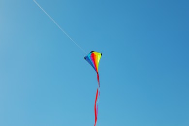 Photo of One colorful kite flying in blue sky