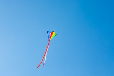 Photo of One colorful kite flying in blue sky