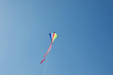 Photo of One colorful kite flying in blue sky