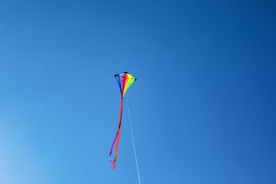 Photo of One colorful kite flying in blue sky