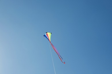 Photo of One colorful kite flying in blue sky
