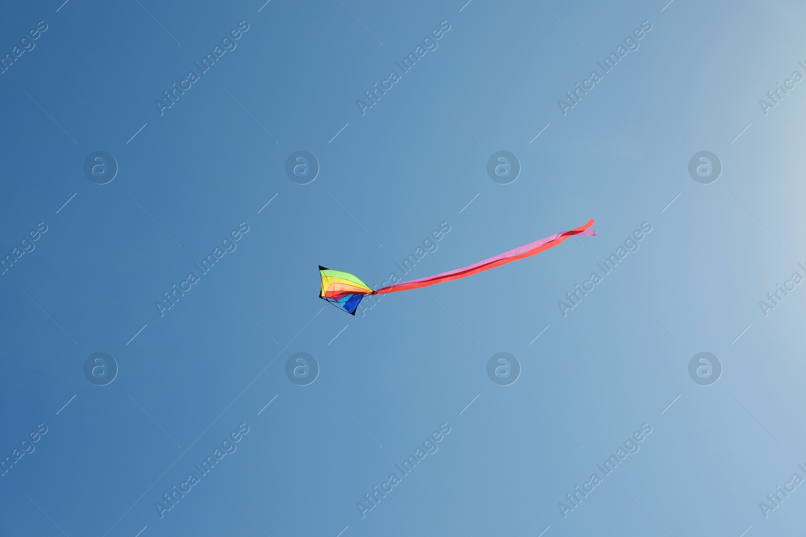 One colorful kite flying in blue sky Photo of One colorful kite flying in blue sky