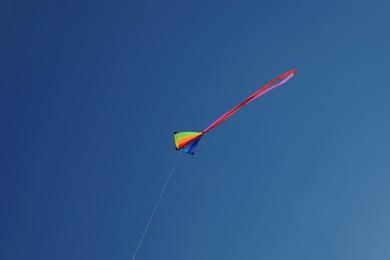Photo of One colorful kite flying in blue sky