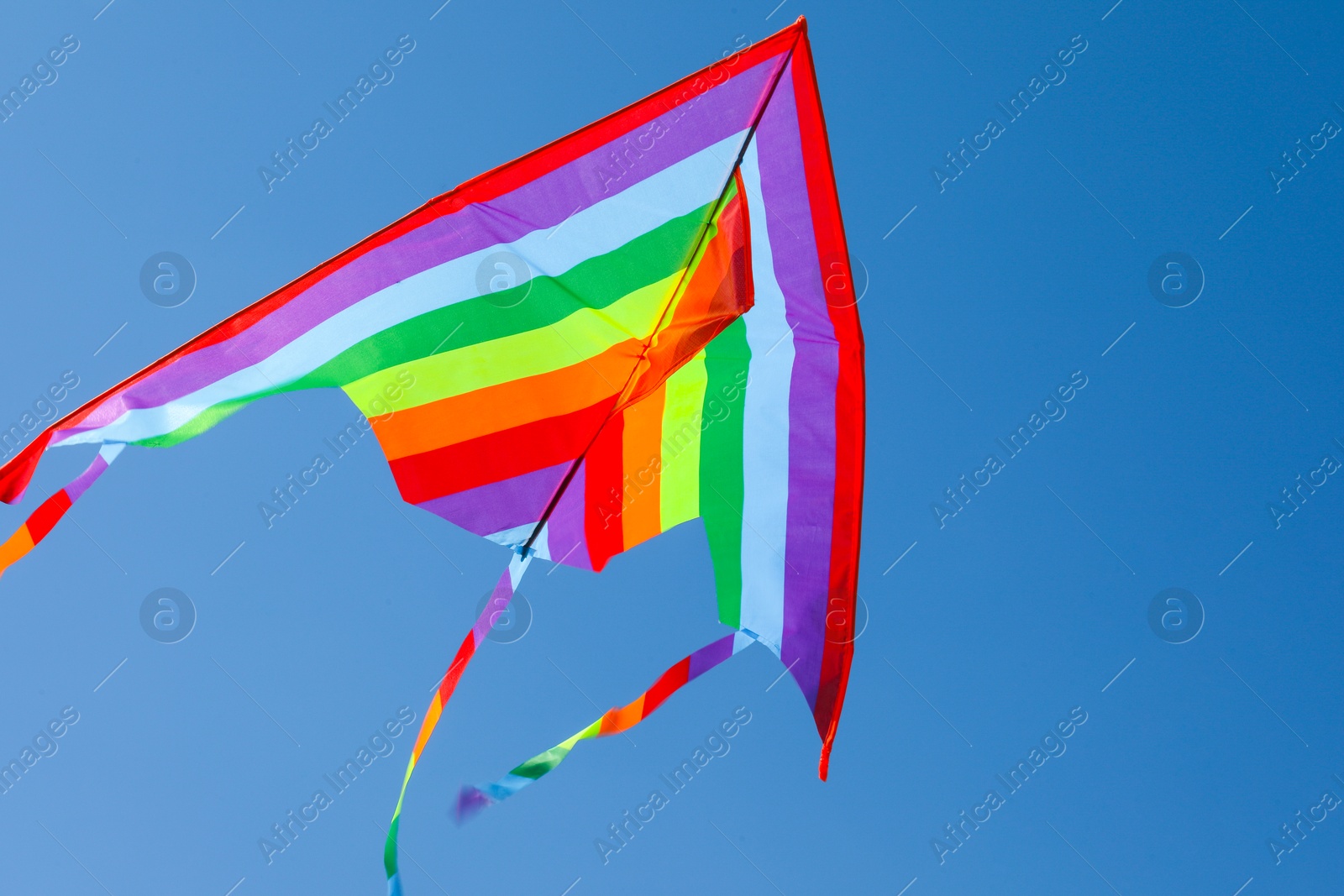 One colorful kite flying in blue sky Photo of One colorful kite flying in blue sky