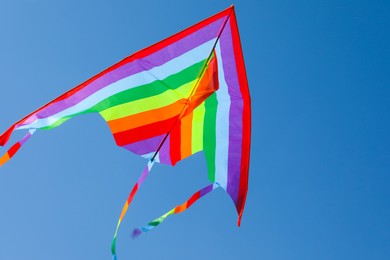 Photo of One colorful kite flying in blue sky