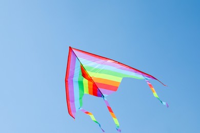 Photo of One colorful kite flying in blue sky