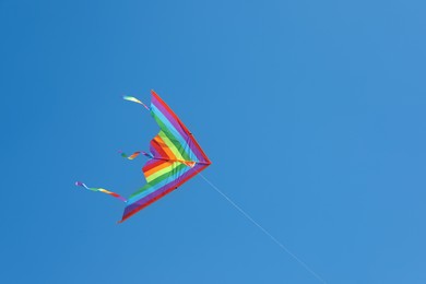 Photo of One colorful kite flying in blue sky
