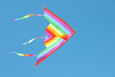 Photo of One colorful kite flying in blue sky