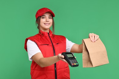 Photo of Girl in uniform with paper bag and payment terminal on green background. Work for teenagers