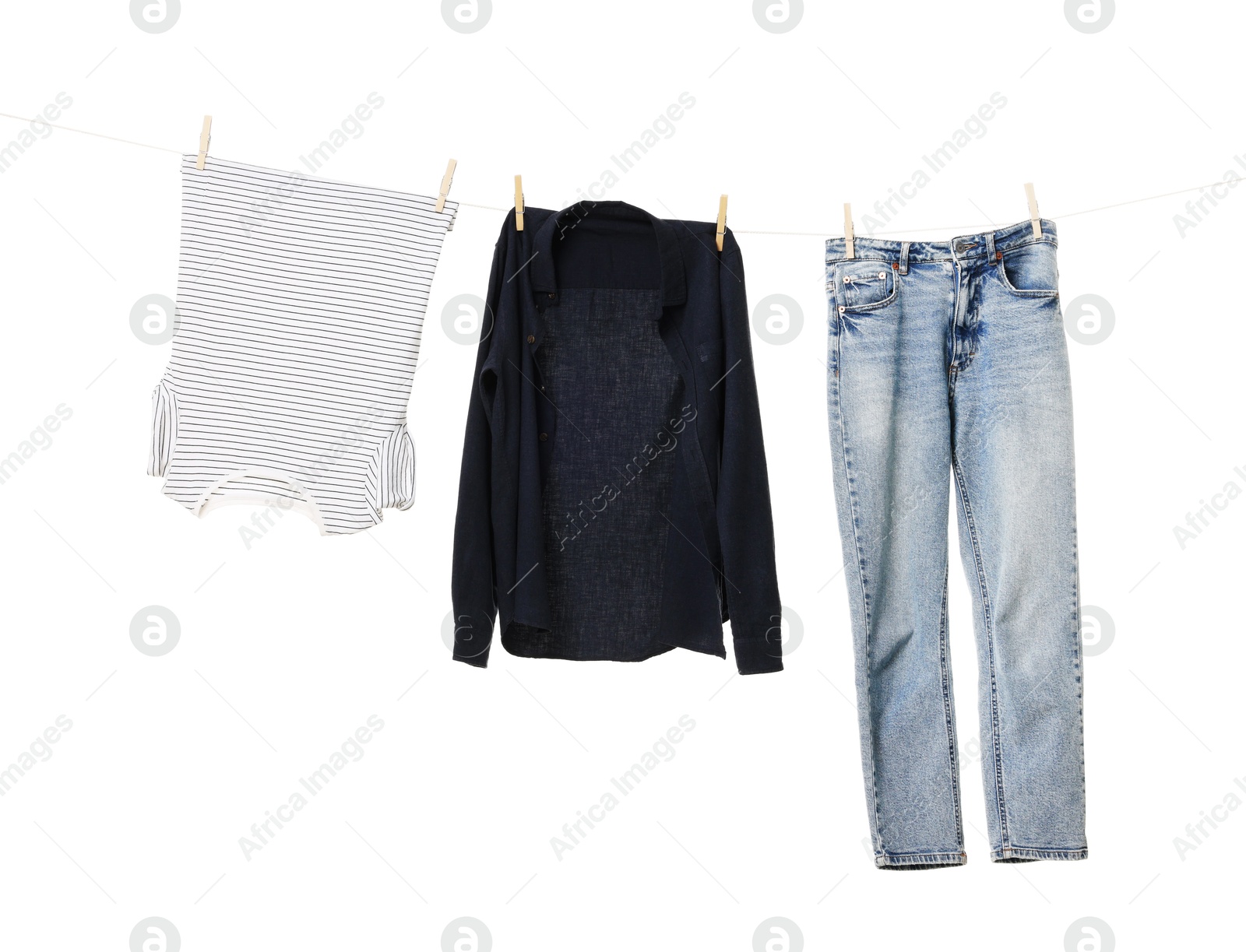 Photo of Different clothes drying on laundry line against white background