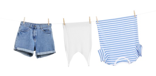 Photo of Different clothes drying on laundry line against white background