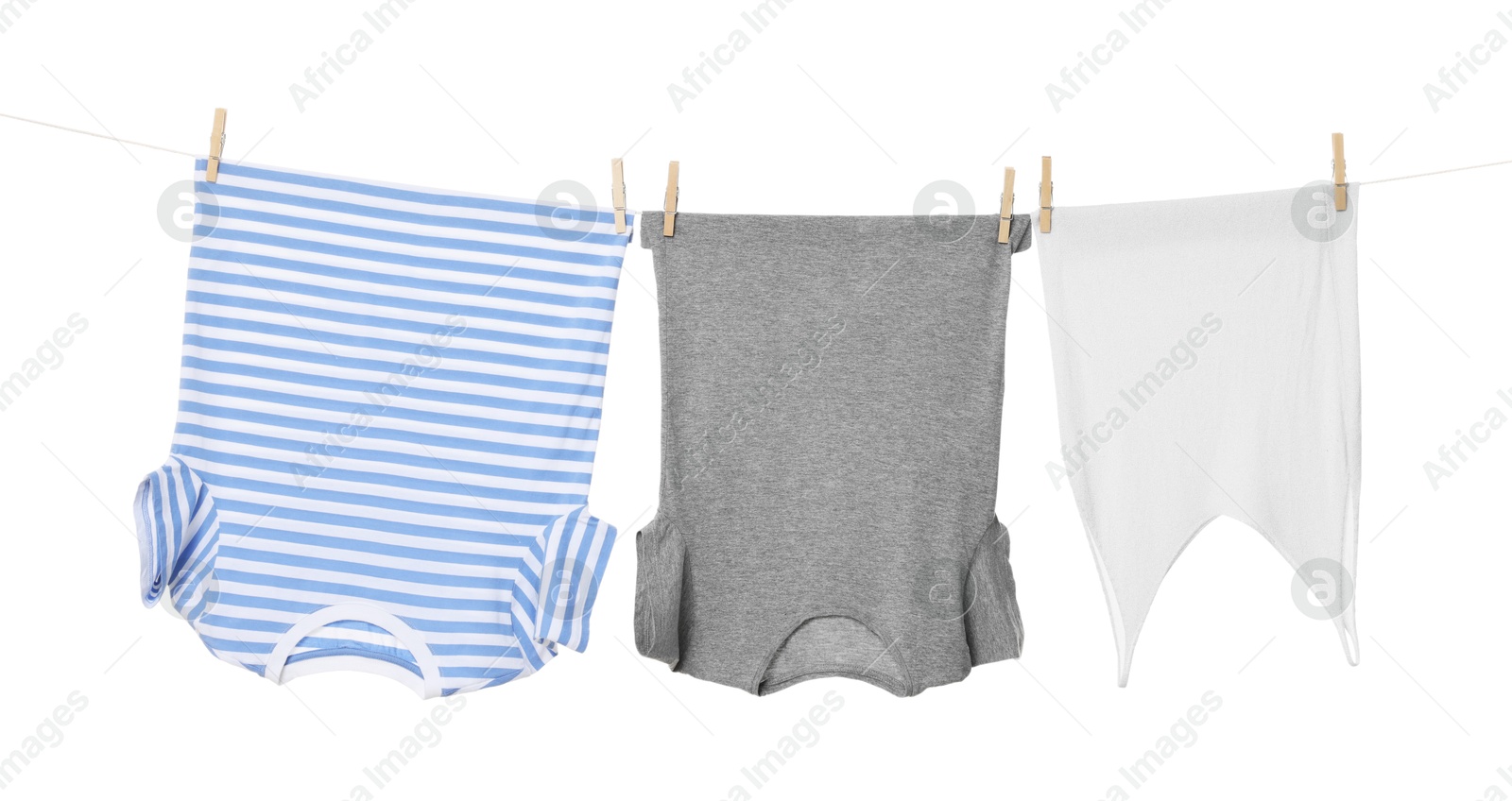 Photo of Different clothes drying on laundry line against white background