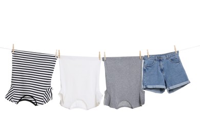 Photo of Different clothes drying on laundry line against white background