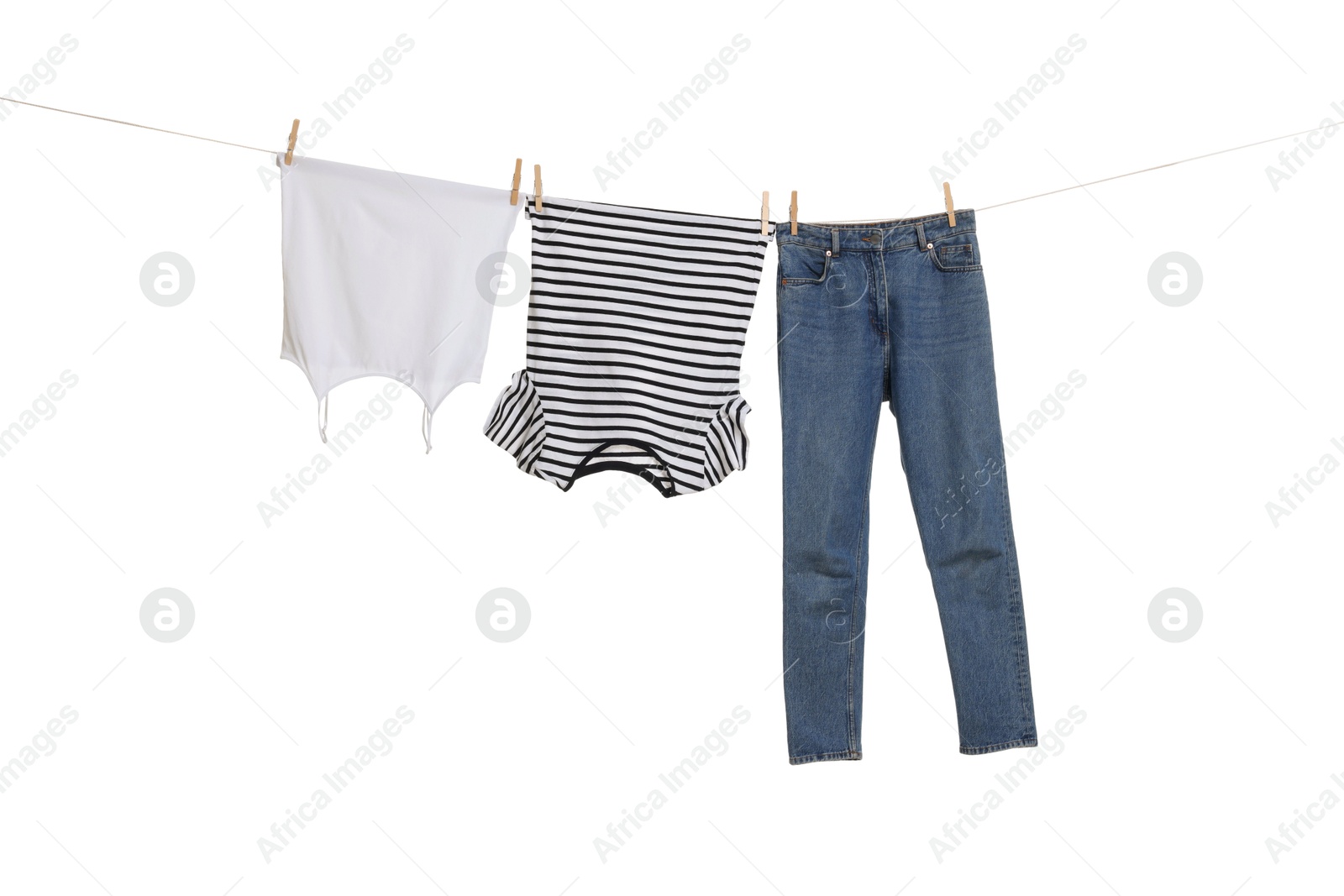 Photo of Different clothes drying on laundry line against white background