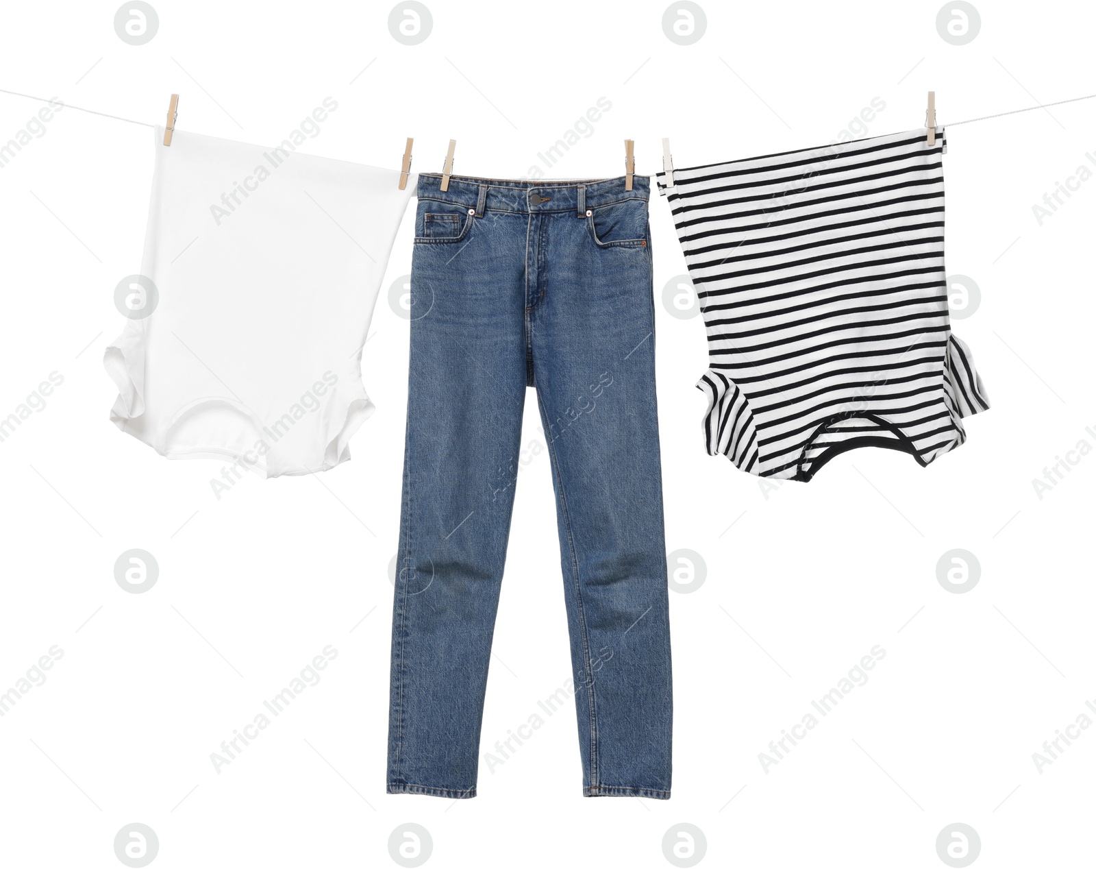 Photo of Different clothes drying on laundry line against white background