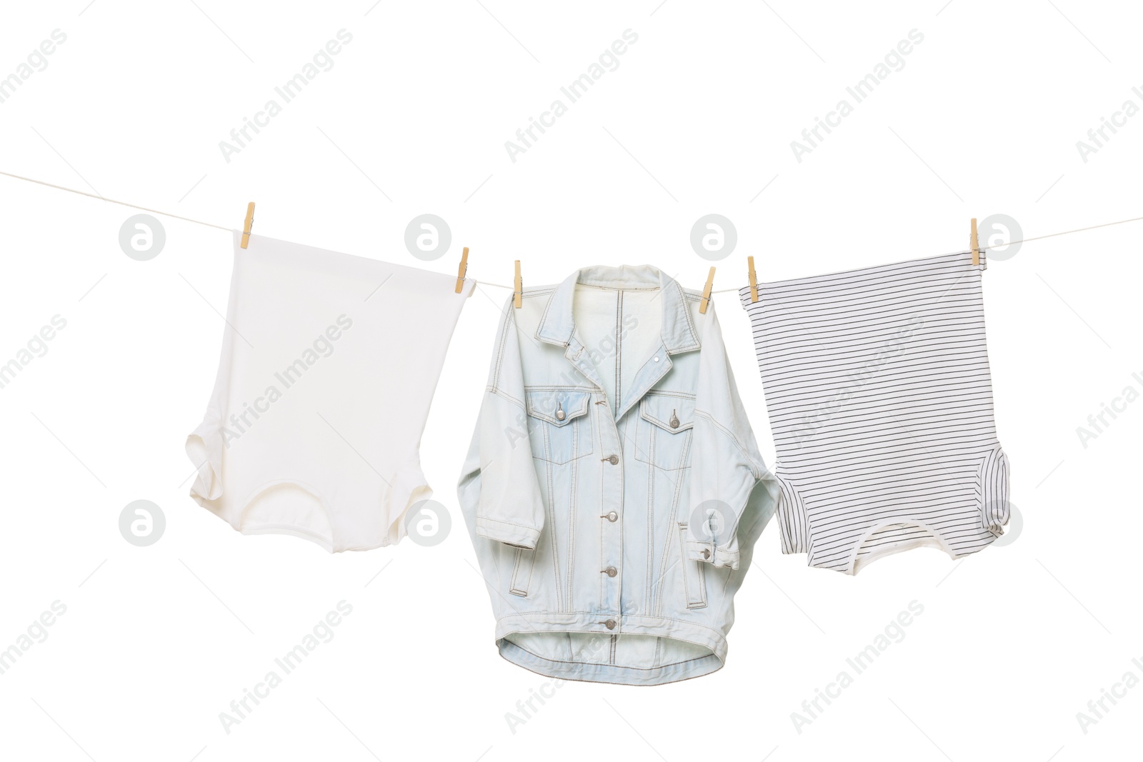 Photo of Different clothes drying on laundry line against white background