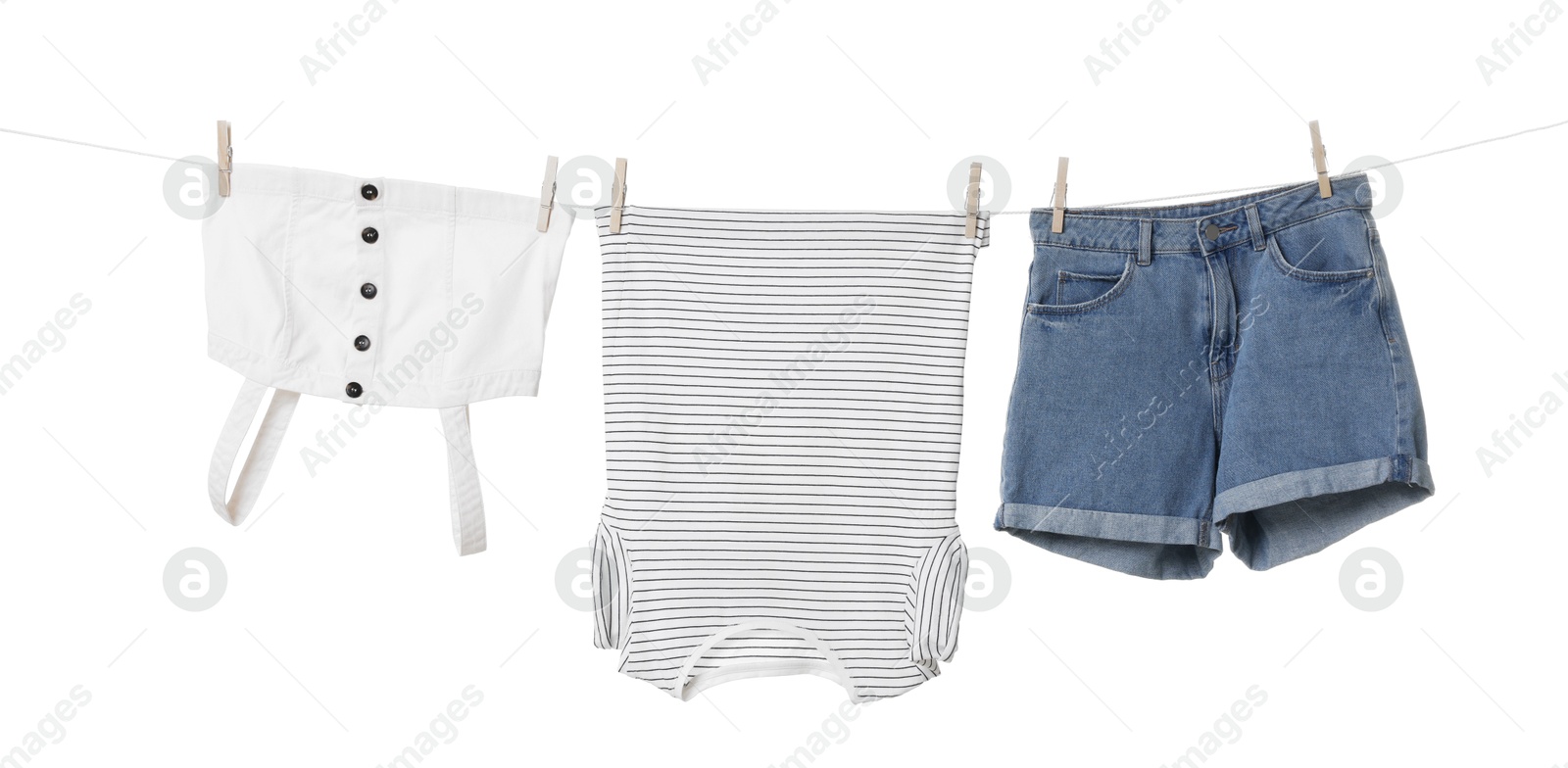 Photo of Different clothes drying on laundry line against white background