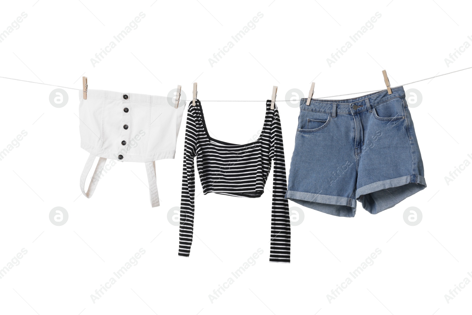 Photo of Different clothes drying on laundry line against white background