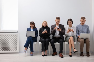 Photo of Group of people using different gadgets indoors. Modern technology