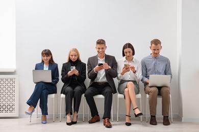 Photo of Group of people using different gadgets indoors. Modern technology