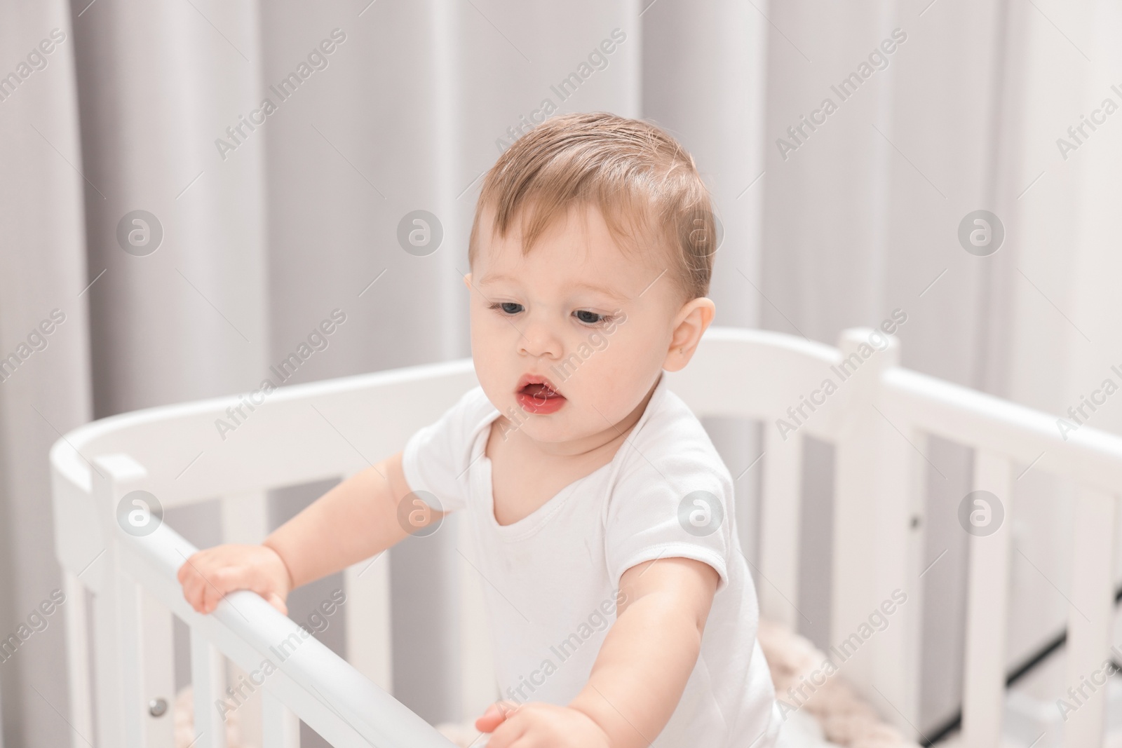 Photo of Cute little baby in crib at home