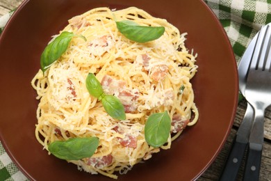 Photo of Delicious pasta Carbonara served on table, flat lay