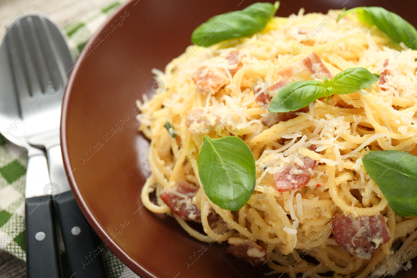 Photo of Delicious pasta Carbonara served on table, closeup