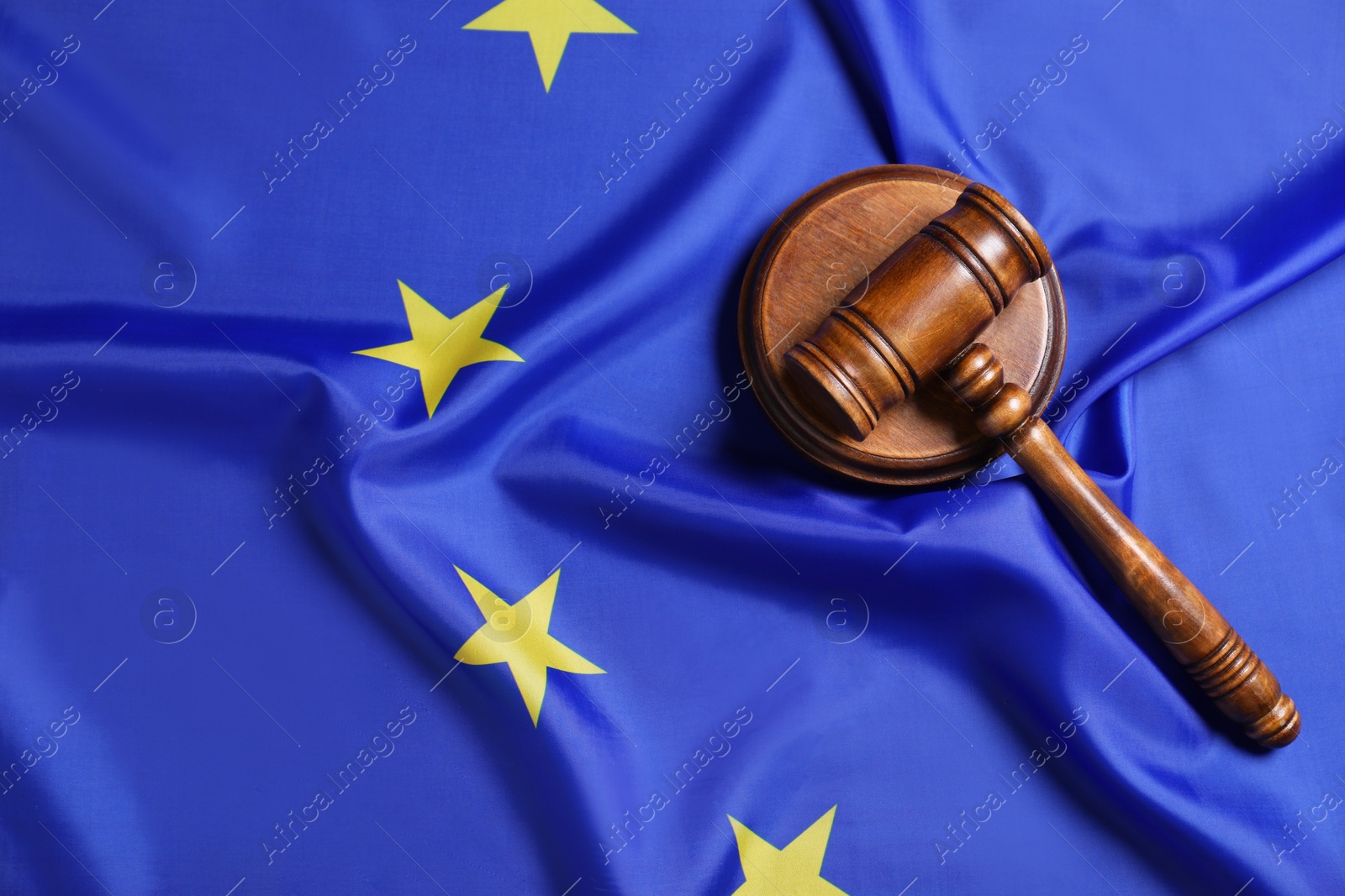 Photo of Judge's gavel on flag of European Union, top view. Space for text