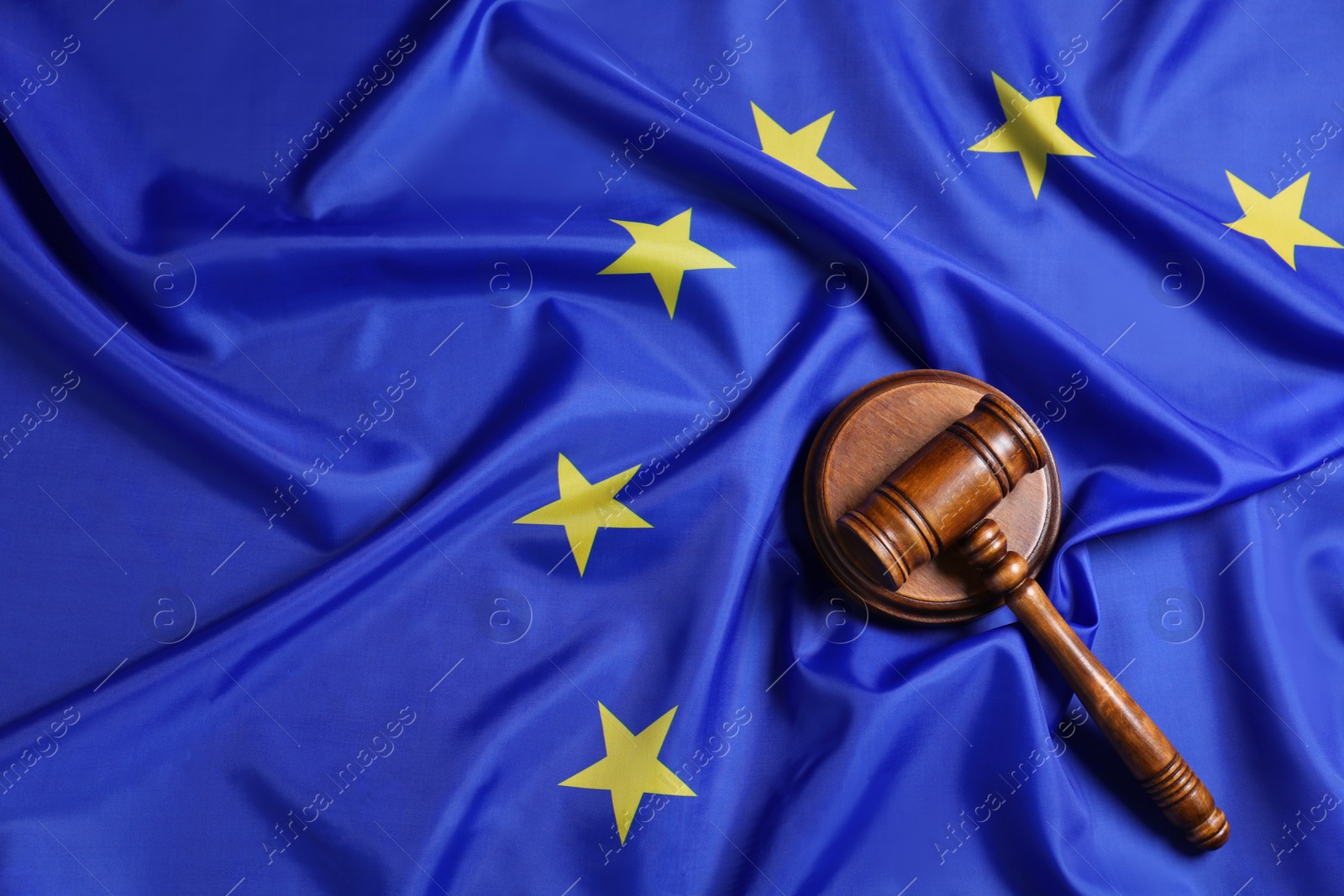 Photo of Judge's gavel on flag of European Union, top view. Space for text