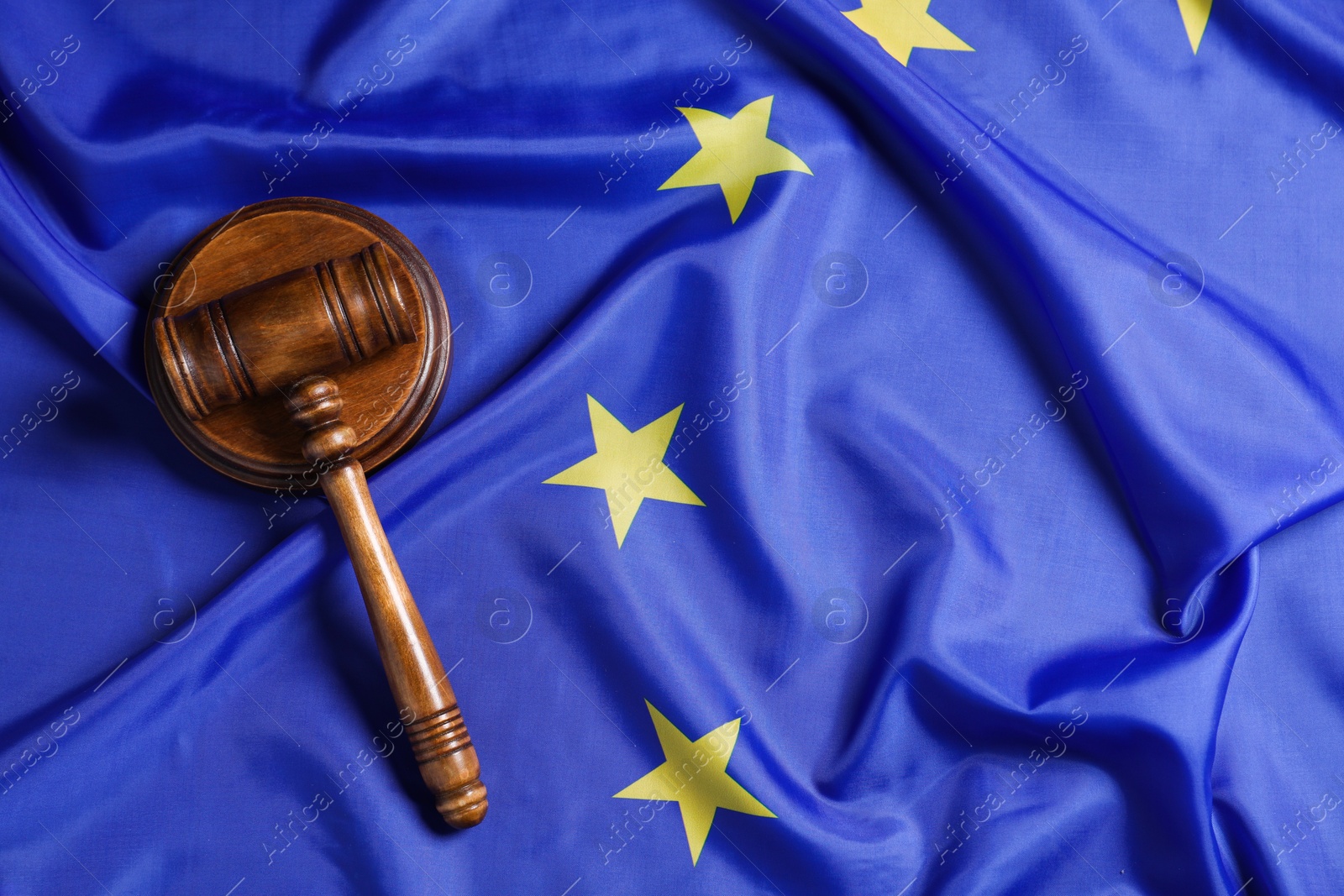 Photo of Judge's gavel on flag of European Union, top view. Space for text