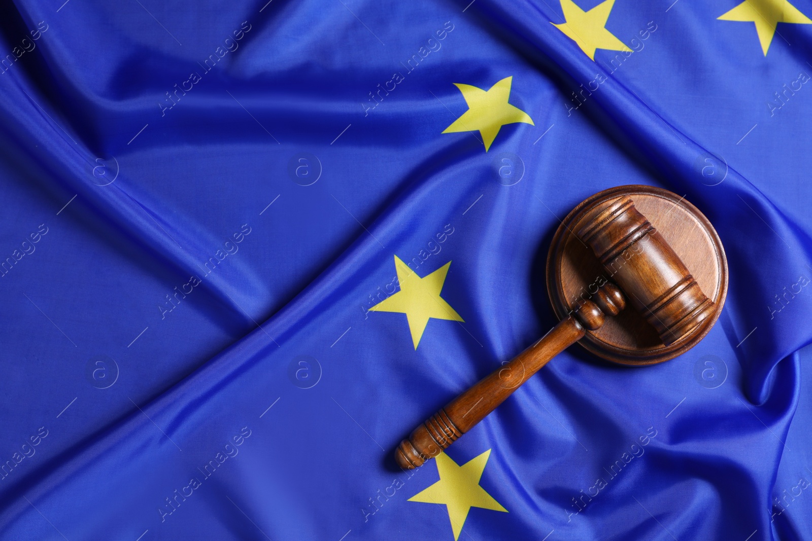 Photo of Judge's gavel on flag of European Union, top view. Space for text