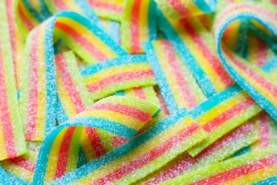 Photo of Tasty rainbow sour belts as background, closeup