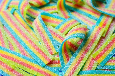 Photo of Tasty rainbow sour belts as background, closeup